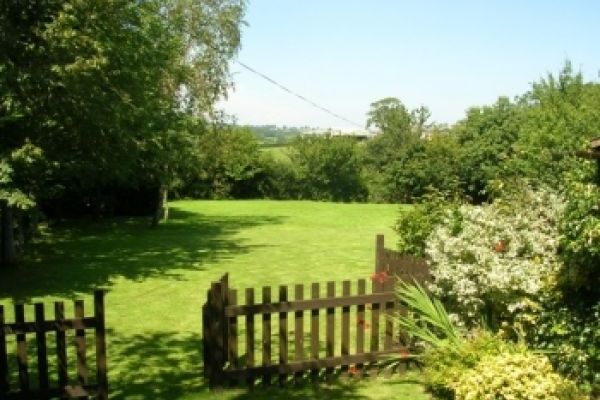 The patio opens onto the meadow