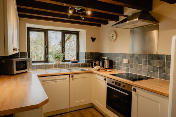 Watch the birds from the kitchen window in Meadow Cottage
