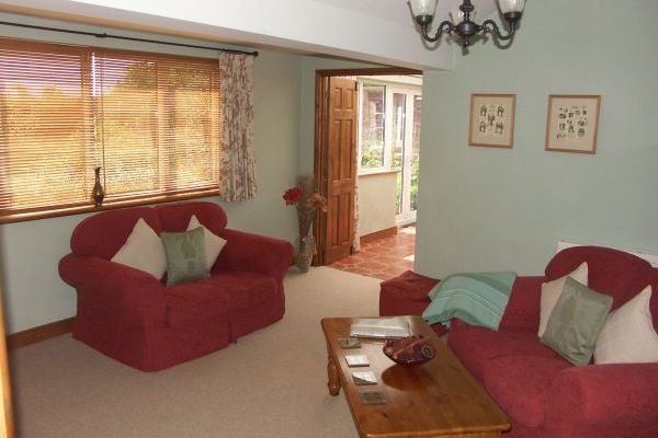 Lounge with conservatory beyond facing front garden