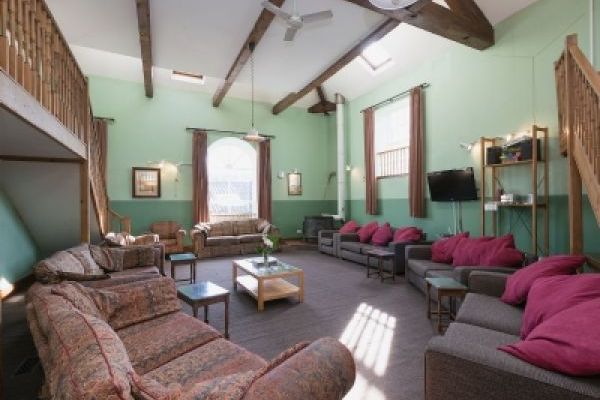 Lounge with plenty of seating, wood burning stove and sauna.